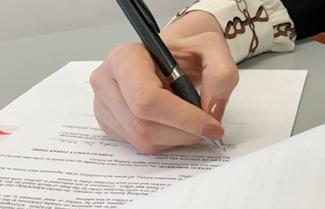 Hand signing a legal document