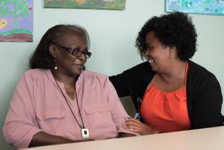 Two women sitting together smiling