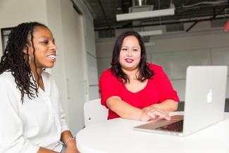 Two women looking at a laptop