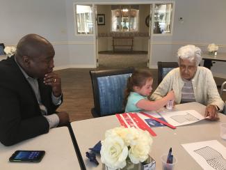 A grandparent and grandchild drawing together